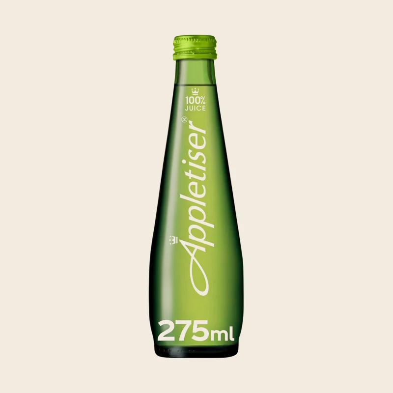 A chilled bottle of Appletiser on a dark table